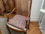 a chair with a cushion on it in a room