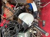un tas de bric-à-brac dans une boîte rouge posée par terre