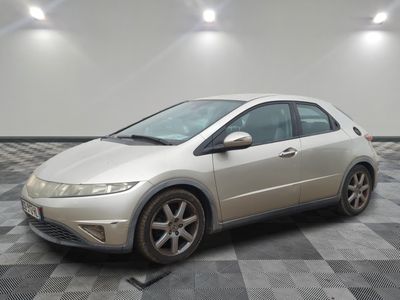 a picture of a silver honda civic car in a garage