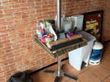 a small table with a bottle of soda on it