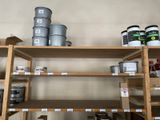 a shelf with cans and cans of paint on it