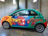 a colorful car with graffiti on the side of it