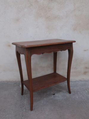 a small wooden table with a shelf on top of it