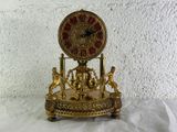 a gold clock that is sitting on top of a table