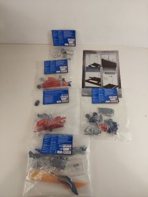 a lot of screws, screws, and other items on the table