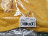 a close up of a yellow sweater with a price tag on it