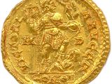 a gold coin with an image of a man on a horse