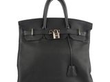 a black leather handbag on a white background