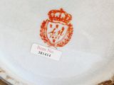a close up of a plate with a crown on it