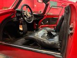 a red car with a leather seat and steering wheel