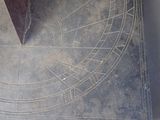 a sundial on the floor of a building