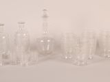 bottles and glasses are lined up on a white surface