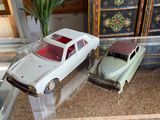 two toy cars sitting on a glass table in a living room