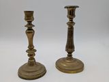 pair of antique brass candlesticks on a white background