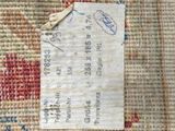 a close up of a piece of fabric with a piece of paper on it