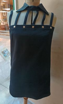 a mannequin with a black dress on a mannequin stand
