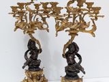 pair of antique bronze candelabs with figures on pedestals