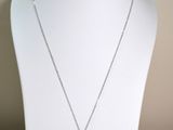 yellow and white diamond pendant on a white mannequin necklace