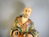 a statue of a man with a beard holding a pot