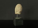 a statue of a man ' s head on a black table