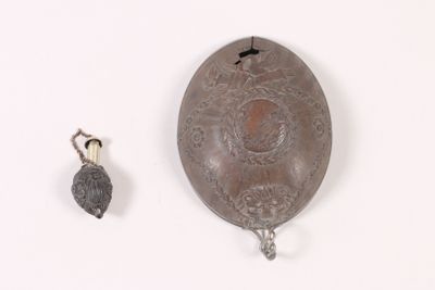 a metal object that is sitting next to a small object