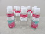 six bottles of hand sanitizer are lined up on a table