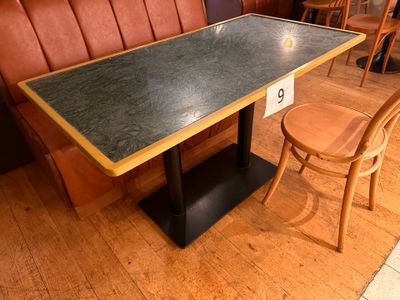 a table and two chairs in the corner of a booth