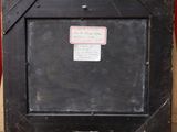 a picture of a black picture frame with a label on it