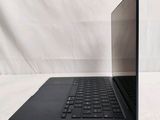 a black laptop with a black keyboard on a white surface