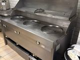 a stainless steel stove with two burners in a kitchen