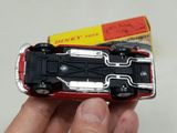 a person holding a toy car in their hand