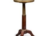 a small wooden table with a gold top on a white background