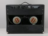 a black amp with two beer cans in it