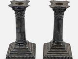pair of antique cast iron candlesticks on pedestals