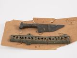 a knife and a knife holder on a piece of paper