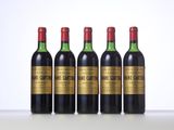 four bottles of wine are lined up on a table