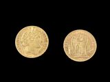 two pieces of gold coins on a black background