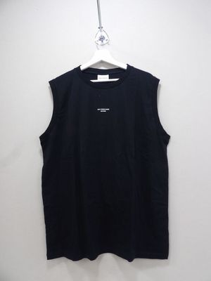a black shirt hanging on a hanger on a wall