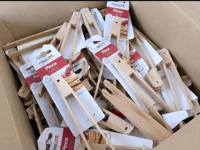 a cardboard box filled with wooden spoons and spatulas