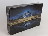 two boxes with a batman logo on them sitting on a white surface