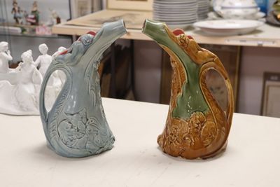 two vases that are sitting on a table