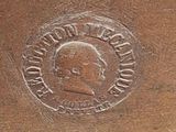 a bronze statue of a man with a medallion on it