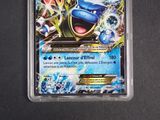 a close up of a pokemon card in a plastic container
