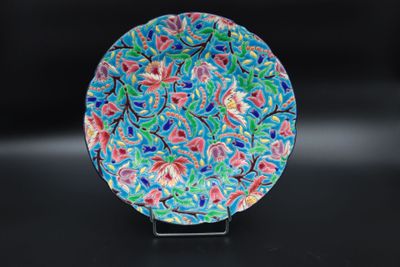 an image of a colorful plate sitting on top of a black table
