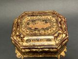 an ornately decorated box sitting on top of a table