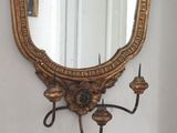 a mirror on the wall above a sink in a bathroom