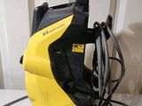 yellow and black pressure washer sitting on top of a white table
