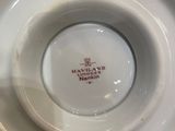 a white plate with a red and white design on it