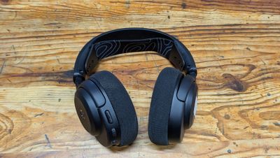 un casque audio noir posé sur une table en bois