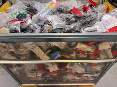 beaucoup d'appareils électroniques dans un bac posé par terre